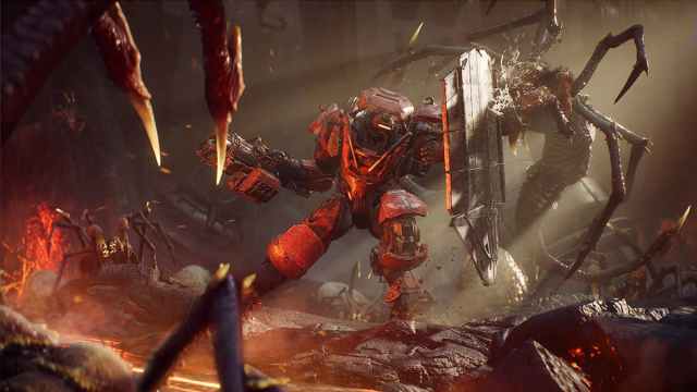 Image of a character in Anthem fighting some aliens.