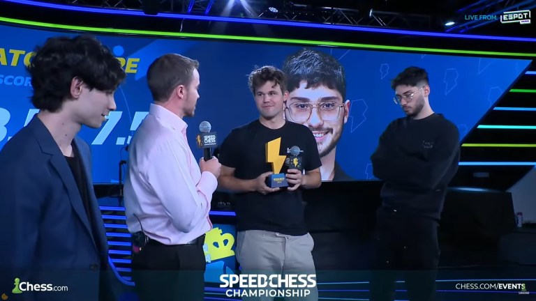 Carlsen holding the SCC 2024 trophy in the post-match interview