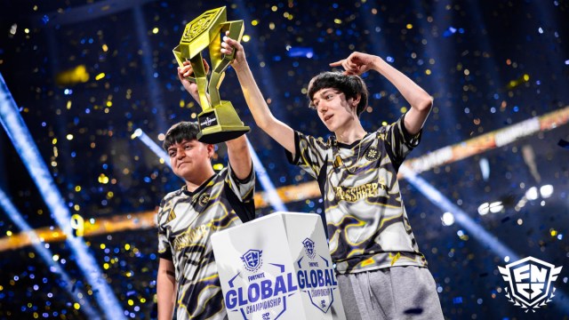 Peterbot and Pollo lift the FNCS Championship trophy while confetti falls around them.