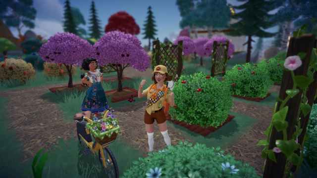 Standing in a fruit orchard with Mirabel in Disney Dreamlight Valley.