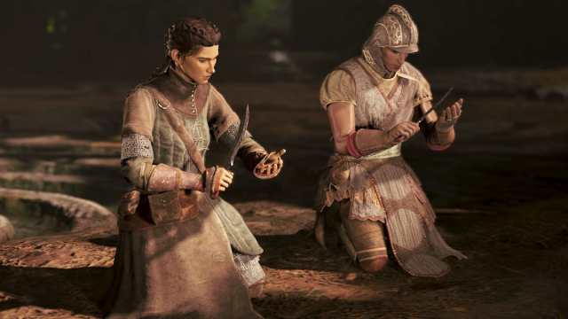 Two characters kneeling while holding knives in GreedFall 2.