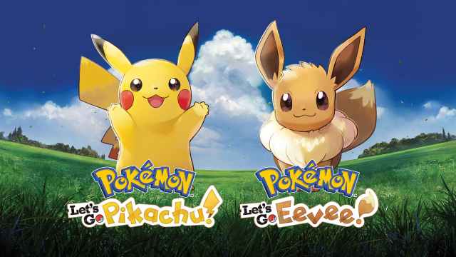 Pikachu and Eevee stand in a field.