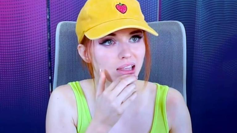 Amouranth rubs her chin while thinking about something she's watching during her Kick stream