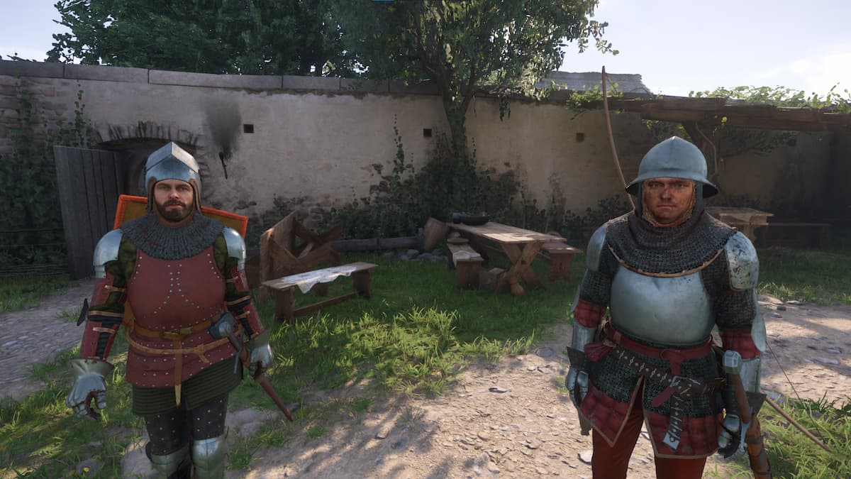 Two men wearing armor along a path in Kingdom Come 2