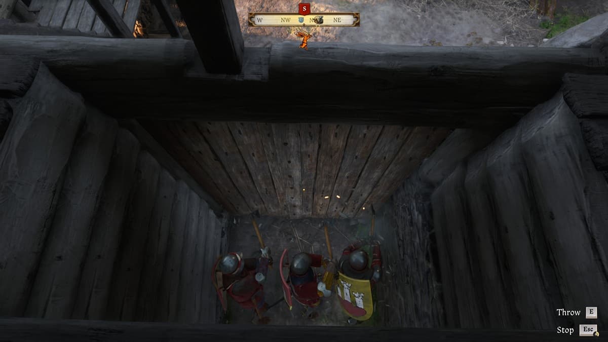 Three soldiers clad in armor storming a wooden gate