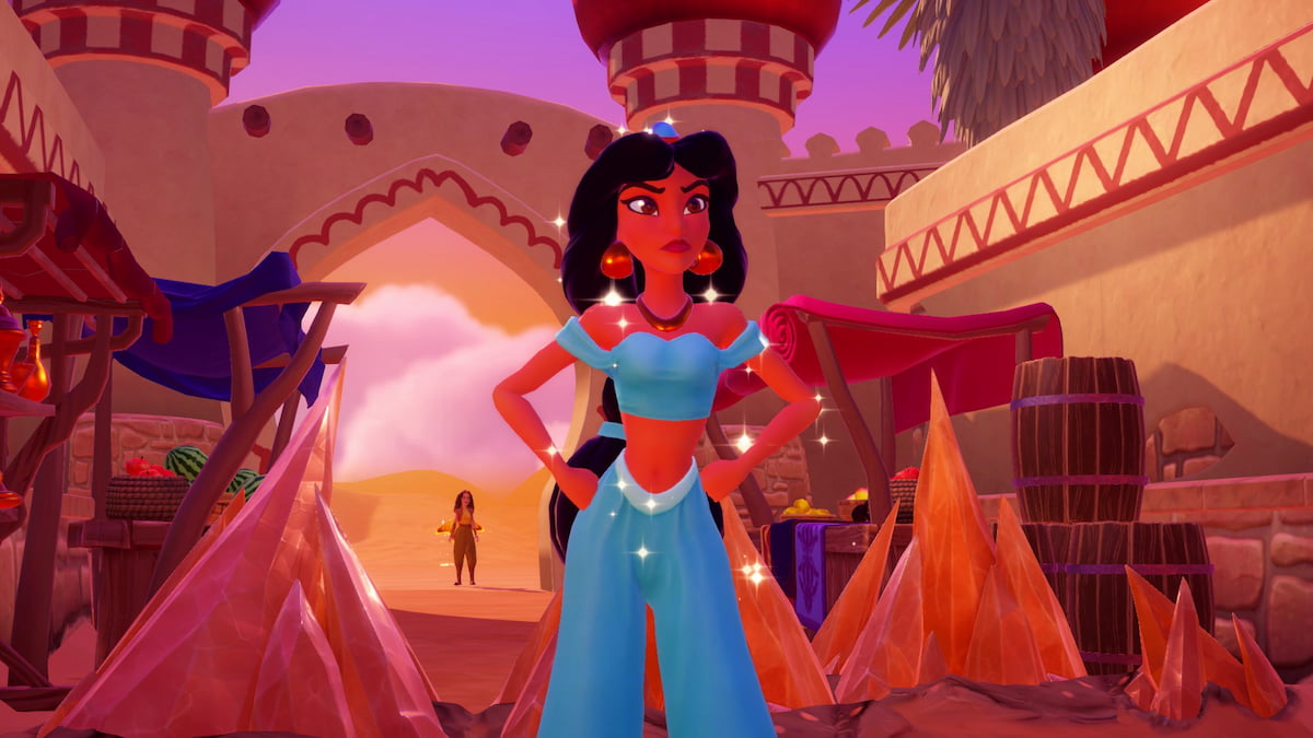 The player standing behind some rocks looking at Jasmine standing with her hands on her hips in disney dreamlight valley.