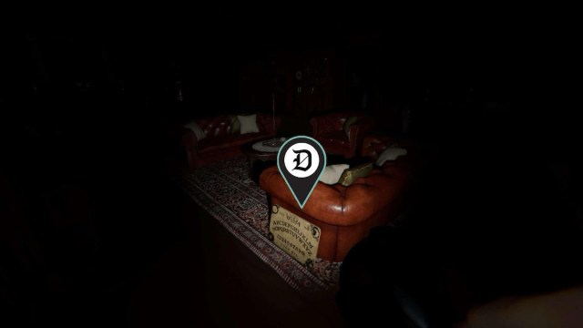 A Ouija Board by a red couch the first floor of Bleasdale Farmhouse in Phasmophobia.
