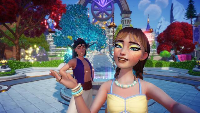 A player wearing a yellow and blue shirt and with long brown braids taking a picture with Aladdin in Disney Dreamlight Valley