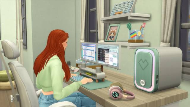 A Sim with orange hair and a light green jacket using a computer in The Sims 4.